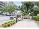 Condominium entrance with lush landscaping, security booth, and gated access for privacy at 3211 W Swann Ave # 502, Tampa, FL 33609