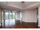 Bright open living room with hardwood floors, access to balcony, and neutral paint at 3211 W Swann Ave # 502, Tampa, FL 33609