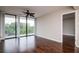 Bright living room with hardwood floors, neutral walls, and access to balcony, with ceiling fan at 3211 W Swann Ave # 502, Tampa, FL 33609