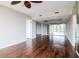 Open living space with hardwood floors, ceiling fan, and access to balcony overlooking trees at 3211 W Swann Ave # 502, Tampa, FL 33609