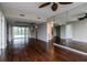 Spacious living room with hardwood floors, ceiling fans, and a mirrored wall to enhance the space at 3211 W Swann Ave # 502, Tampa, FL 33609