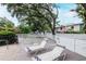 Community pool deck with lounge chairs and a privacy fence creating a relaxing outdoor space at 3211 W Swann Ave # 502, Tampa, FL 33609