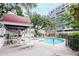 Inviting community pool area with kitchen, tables, and comfortable lounge chairs for residents' enjoyment at 3211 W Swann Ave # 502, Tampa, FL 33609