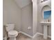 A well-lit powder room with a pedestal sink, offering convenience for guests and everyday use at 3921 Kearsney Abbey Cir, Dover, FL 33527