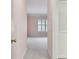 Hallway leading into a carpeted bedroom with a light pink walls at 4044 Priory Cir, Tampa, FL 33618