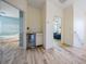 Hallway with mini fridge area, luxury wood floors, and doorways leading to bedrooms at 409 Winterside Dr, Apollo Beach, FL 33572