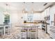 Bright kitchen with white cabinets, granite countertops, a center island and stainless steel appliances at 409 Winterside Dr, Apollo Beach, FL 33572