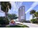 Beautiful condominium building exterior featuring lush landscaping at 450 S Gulfview Blvd # 605, Clearwater Beach, FL 33767