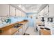 The galley kitchen has bright cabinets, wood countertops and is adjacent to the dining area at 450 S Gulfview Blvd # 605, Clearwater Beach, FL 33767