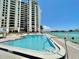Sparkling pool overlooking the ocean with sundeck and lounge chairs at 450 S Gulfview Blvd # 605, Clearwater Beach, FL 33767