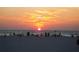 Beautiful sunset scene on a beach with people enjoying the view as the sun sets over the water at 450 S Gulfview Blvd # 605, Clearwater Beach, FL 33767
