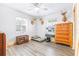 Bright bedroom features wood floors and ample storage with wooden dressers at 510 1/2 Ulelah Ave, Palm Harbor, FL 34683