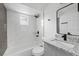 Renovated bathroom featuring a sleek granite vanity and a modern bathtub with marble surround at 5220 Pine St, Seffner, FL 33584