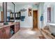 Ensuite bathroom featuring double vanity, tiled shower, and a separate soaking tub at 541 Treviso Dr, Apollo Beach, FL 33572