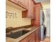 Well-organized laundry room with wooden cabinets, granite counters, and washer/dryer at 541 Treviso Dr, Apollo Beach, FL 33572