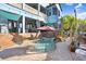 Backyard view showcasing a custom pool, spa, lush landscaping, and a charming two-story house with a balcony at 541 Treviso Dr, Apollo Beach, FL 33572