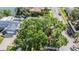 Overhead view of the property showing the expansive tree coverage, nearby lake, and neighborhood at 6041 16Th Ne Ln, St Petersburg, FL 33703