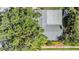 Aerial shot of a home with a mature tree, vibrant landscaping, and a well-maintained roof at 6041 16Th Ne Ln, St Petersburg, FL 33703