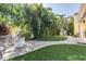 Beautiful backyard with a stone paver pathway, fire pit, mature landscaping, and an outdoor seating area at 6041 16Th Ne Ln, St Petersburg, FL 33703