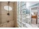 Tiled walk-in shower with glass block partition, integrated seat, and modern fixtures in stylish bathroom at 6041 16Th Ne Ln, St Petersburg, FL 33703