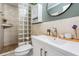 Bright bathroom featuring tiled walls, glass block window, and updated vanity at 6041 16Th Ne Ln, St Petersburg, FL 33703