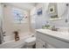 Bright bathroom with tub and shower combination, decorative art, and a large window at 6041 16Th Ne Ln, St Petersburg, FL 33703