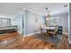 Elegant dining room with hardwood floors and a rustic wood table, open to the living area at 6041 16Th Ne Ln, St Petersburg, FL 33703