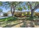 Inviting single-story home with an attached garage, manicured lawn, and vibrant landscaping at 6041 16Th Ne Ln, St Petersburg, FL 33703