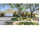 Charming home featuring a manicured lawn, mature trees, and a welcoming two-car garage at 6041 16Th Ne Ln, St Petersburg, FL 33703