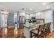 Stylish kitchen features stainless steel appliances, granite counters, a large island, and wood floors at 6041 16Th Ne Ln, St Petersburg, FL 33703