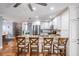 Stylish kitchen features stainless steel appliances, granite counters, a large island, and wood floors at 6041 16Th Ne Ln, St Petersburg, FL 33703