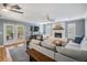 Spacious living room featuring a stone fireplace, ceiling fan, and stylish furniture at 6041 16Th Ne Ln, St Petersburg, FL 33703