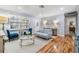 Sunlit living room with hardwood floors, light blue paint, and comfortable seating, with a view at 6041 16Th Ne Ln, St Petersburg, FL 33703