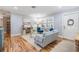 Bright living room with hardwood floors, plantation shutters, and comfortable, modern furnishings at 6041 16Th Ne Ln, St Petersburg, FL 33703