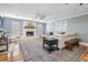 Cozy living room featuring a stone fireplace, ceiling fan, and stylish furniture at 6041 16Th Ne Ln, St Petersburg, FL 33703