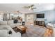 Open-concept living room featuring an updated kitchen, ceiling fan, and stylish furniture at 6041 16Th Ne Ln, St Petersburg, FL 33703