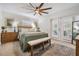 Serene main bedroom featuring neutral colors, french doors, ceiling fan, and wooden furniture at 6041 16Th Ne Ln, St Petersburg, FL 33703