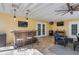 Covered outdoor patio with a bar, barstools, lounge area with comfortable furniture and televisions at 6041 16Th Ne Ln, St Petersburg, FL 33703