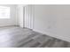 Clean bedroom featuring light gray wood floors and a double door closet at 6906 N Lynn Ave, Tampa, FL 33604