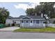 Charming single-story home featuring a cozy front porch and a convenient carport at 6906 N Lynn Ave, Tampa, FL 33604