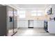 Bright kitchen with stainless steel appliances, white cabinets, and lots of natural light at 6906 N Lynn Ave, Tampa, FL 33604