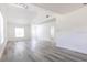 Bright and spacious living room with vaulted ceilings and modern gray flooring at 6906 N Lynn Ave, Tampa, FL 33604