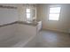 Modern bathroom with dual vanity sinks, a soaking tub, and tiled floors at 70 Durham Ct, Palm Harbor, FL 34683