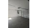 Spacious garage with an automatic door, ample lighting, and a concrete floor at 70 Durham Ct, Palm Harbor, FL 34683