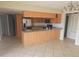 Spacious kitchen with stainless steel refrigerator, granite countertops, and a functional center island at 70 Durham Ct, Palm Harbor, FL 34683