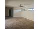 Spacious living room featuring neutral carpeting, a ceiling fan, and natural light from above windows at 70 Durham Ct, Palm Harbor, FL 34683