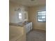 Bright main bathroom boasts a dual sink vanity with granite countertops, tiled floors, and modern fixtures at 70 Durham Ct, Palm Harbor, FL 34683