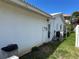 Exterior side of home with white walls, small windows and a small patch of grass at 701 64Th Ave, St Pete Beach, FL 33706