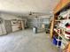 Spacious two car garage with overhead door, open storage shelves, and concrete flooring at 701 64Th Ave, St Pete Beach, FL 33706
