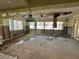 Spacious living room renovation with damaged ceiling, flooring, exposed walls, and natural light at 701 64Th Ave, St Pete Beach, FL 33706